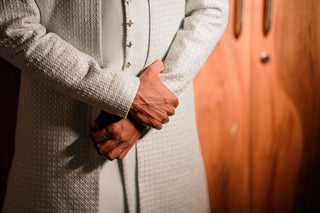 Close-up of a man in an embroidered sherwani, showcasing elegant traditional Indian fashion.