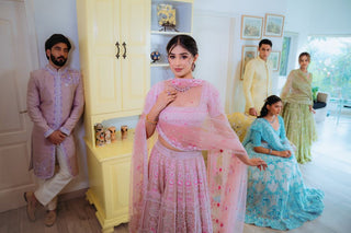 Group showcasing colorful traditional Indian attire in modern setting.