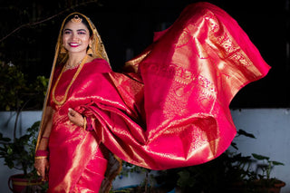 Smiling Indian woman in traditional red saree, showcasing Indian culture and fashion.