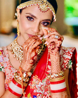 Founder in red bridal lehenga