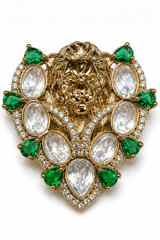 Flat product view of the gold and emerald green lion brooch with white stones showing symmetrical white and green stone border at Mrs. G