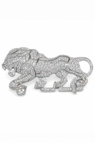 Flat product view of the silver zircon lion brooch showing zircon-covered body with a round stone accent at Mrs. G