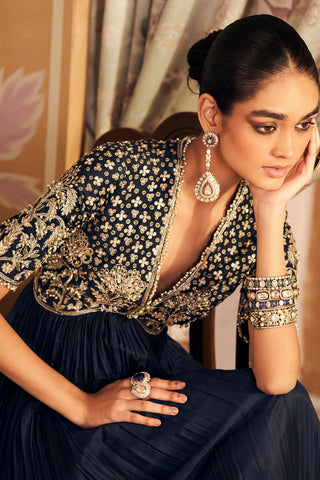 Close-up of the navy zarqaa anarkali's plunging V-neck yoke with gold zari, sequin and floral embroidery at Mrs. G