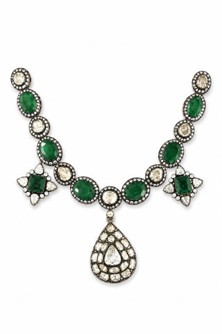 Flat product view of the emerald green polki pendant necklace showing ornate teardrop pendant at the center at Mrs. G