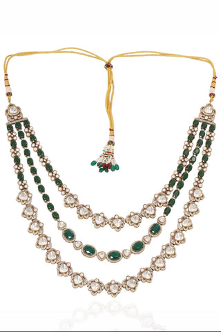 Flat product view of the emerald green three-layer beaded kundan mala with tassel dori showing adjustable dori with beaded tassels at Mrs. G