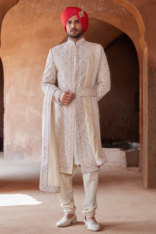 Ivory tarana gold dori embroidered sherwani set by Nitika Gujral at Mrs. G