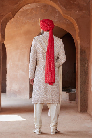 Ivory tarana gold dori embroidered sherwani set by Nitika Gujral at Mrs. G