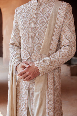 Ivory tarana gold dori embroidered sherwani set by Nitika Gujral at Mrs. G