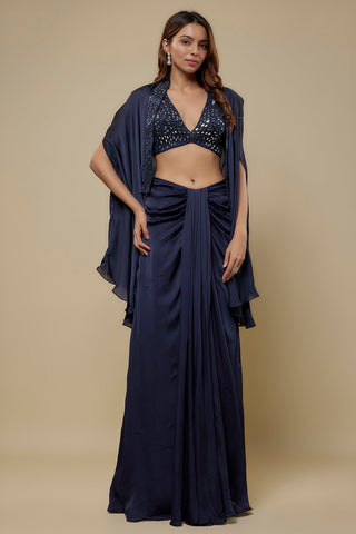 Front view of a navy mirror work plunge blouse and fluid cape over a satin drape skirt by Asaga at Mrs. G