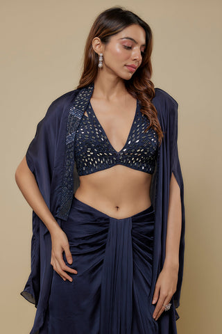 Waist-up view of the navy mirror work V-neck blouse and organza cape with a beaded edge by Asaga at Mrs. G