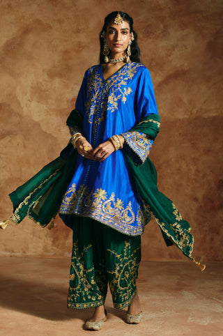 Cobalt blue kurta with the green organza dupatta in motion, showing the gold hem band by Aman Takyar at Mrs. G