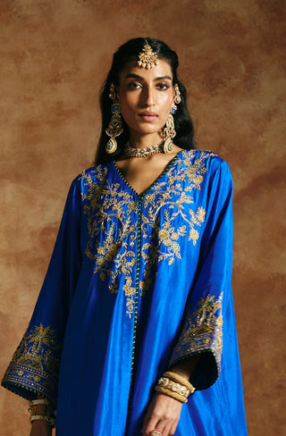 Front view of the cobalt blue kurta's V-neck yoke and flared embroidered cuffs by Aman Takyar at Mrs. G