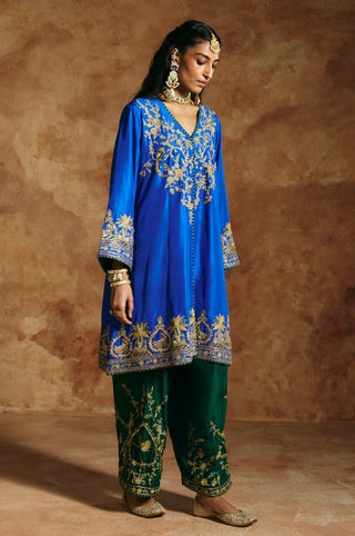 Side view of the cobalt blue kurta and the embroidered deep green pants by Aman Takyar at Mrs. G