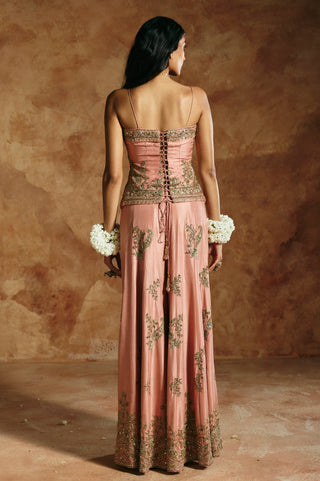 Back view of the onion pink top's lace-up back with tassel ties above the sharara border by Aman Takyar at Mrs. G