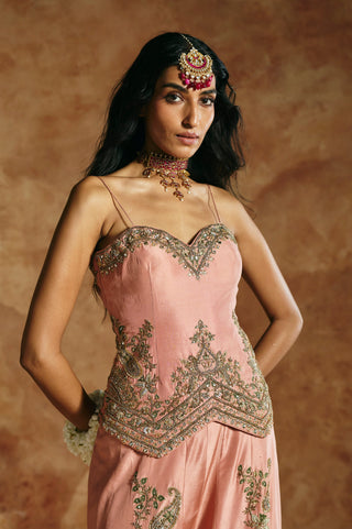 Close-up of the onion pink top's antique-gold sweetheart neckline and chevron hem by Aman Takyar at Mrs. G