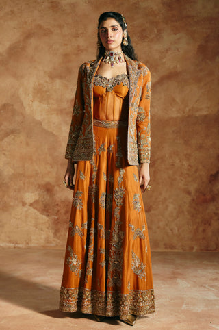 Full-length front view of the orange jacket, corset and sharara set with gold embroidery by Aman Takyar at Mrs. G