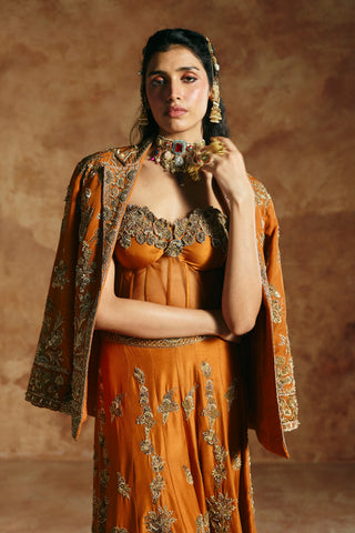 Waist-up view of the orange jacket draped open over the sweetheart corset by Aman Takyar at Mrs. G