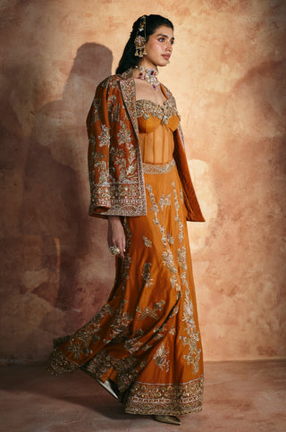 Side view of the orange jacket's embroidered cuffs and the sharara's flowing hem by Aman Takyar at Mrs. G