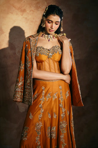 Waist-up view of the orange jacket worn off the shoulders over the corset by Aman Takyar at Mrs. G