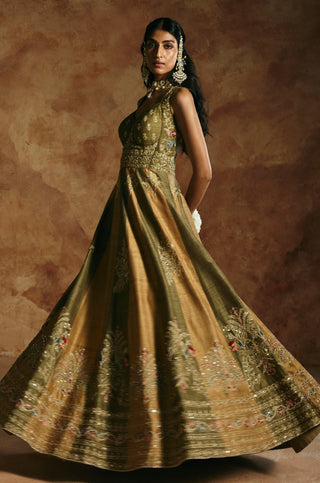 Twirling view of the green rust anarkali set showing the full flare of the paneled skirt by Aman Takyar at Mrs. G