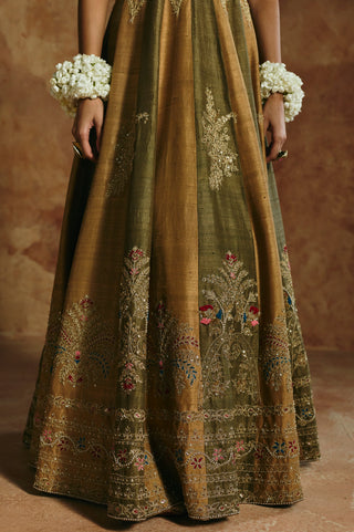 Close-up of the green rust anarkali set hem with embroidered floral sprays by Aman Takyar at Mrs. G