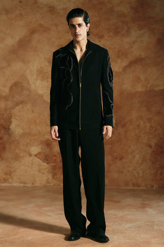 Straight-on full-length view of the black zipper jacket with embroidered sleeve by Aman Takyar at Mrs. G