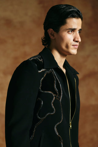 Close-up of the black zipper jacket shoulder with raised beaded cord outlining the embroidery by Aman Takyar at Mrs. G
