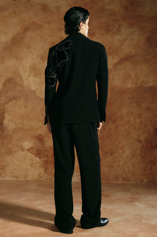 Back view of the black zipper jacket with embroidery across the shoulder and sleeve by Aman Takyar at Mrs. G