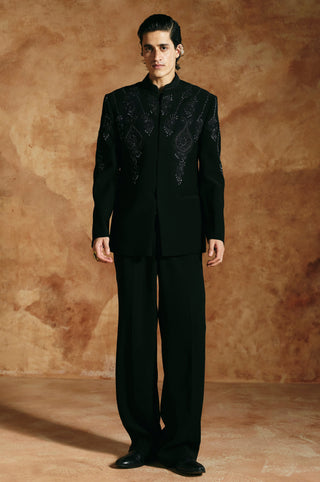 Full-length front view of the black bandhgala set with concealed front placket and relaxed trousers by Aman Takyar at Mrs. G
