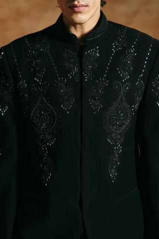 Close-up of the black bandhgala set chest with hand-beaded teardrop motifs and mandarin collar by Aman Takyar at Mrs. G