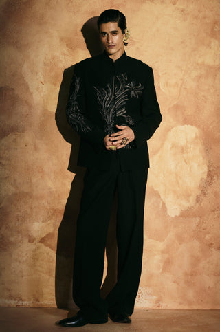 Front view of the black jacket set with a mandarin collar and leaf embroidery on one sleeve by Aman Takyar at Mrs. G
