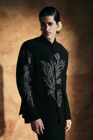 Waist-up view of the black jacket showing gray and silver embroidery on the chest by Aman Takyar at Mrs. G
