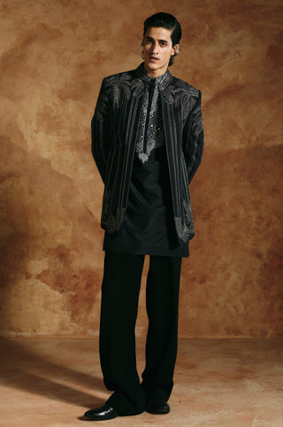 Front view of the black striped jacket worn open over a black kurta with trousers by Aman Takyar at Mrs. G