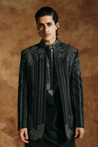 Waist-up front view of the black striped jacket with palm leaves across the shoulders by Aman Takyar at Mrs. G