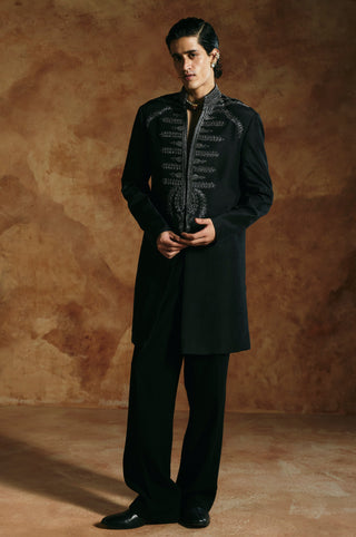 Front view of the black long jacket set with hands together and an embroidered stand collar by Aman Takyar at Mrs. G