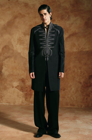 Front view of the black long jacket set with arms relaxed and embroidered shoulders by Aman Takyar at Mrs. G