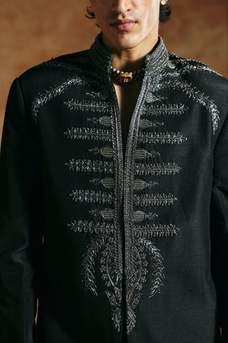 Close-up of the black long jacket collar and zardozi column on the center front by Aman Takyar at Mrs. G