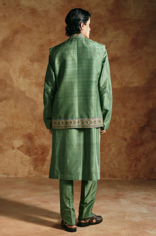 Back view of the green nehru jacket set with a bordered hem at the jacket by Aman Takyar at Mrs. G