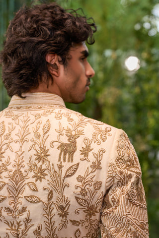 Close-up of the gold deer motif and floral vine embroidery on the sherwani back by Jigar and Nikita at Mrs. G