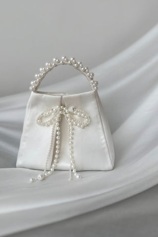 White satin bag with pearl bow