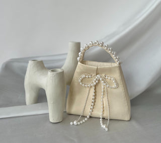 Ivory satin bag with pearl bow