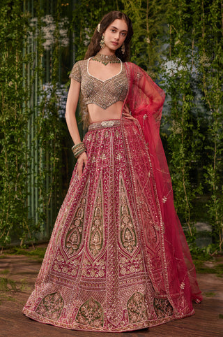 Full-length front view of the pink lehenga set with green appliqué panels and olive blouse by Jigar and Nikita at Mrs. G
