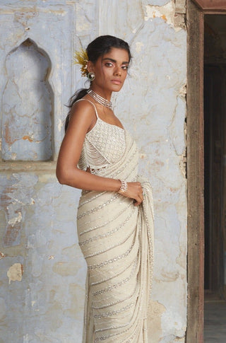 Beige nihaar cutdana crystal saree set by Nitika Gujral at Mrs. G