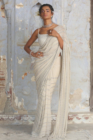 Beige nihaar cutdana crystal saree set by Nitika Gujral at Mrs. G