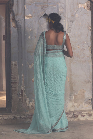 Blue nihaar chiffon sequin saree set by Nitika Gujral at Mrs. G