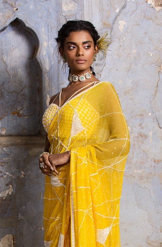 Yellow nihaar feather fringe saree set by Nitika Gujral at Mrs. G