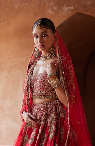 Red tarana cardinal raw silk lehenga set by Nitika Gujral at Mrs. G
