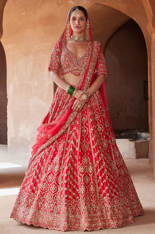 Red tarana vibrant raw silk lehenga set by Nikita Gujral at Mrs. G