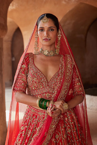 Red tarana vibrant raw silk lehenga set by Nikita Gujral at Mrs. G
