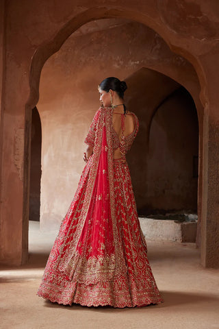 Red tarana vibrant raw silk lehenga set by Nikita Gujral at Mrs. G